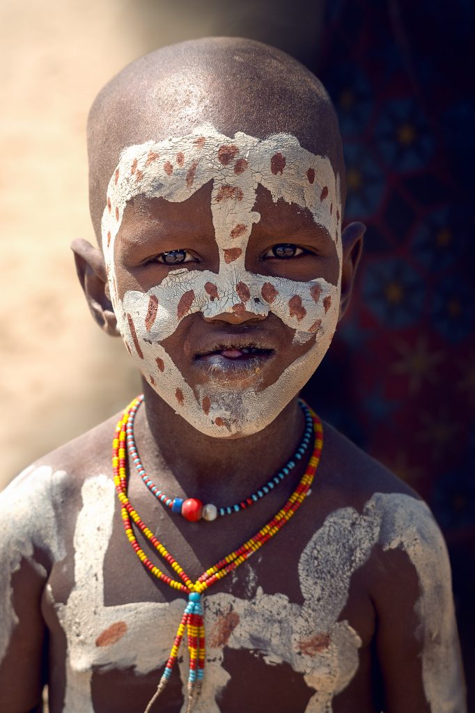 arbore child with a tribal painting