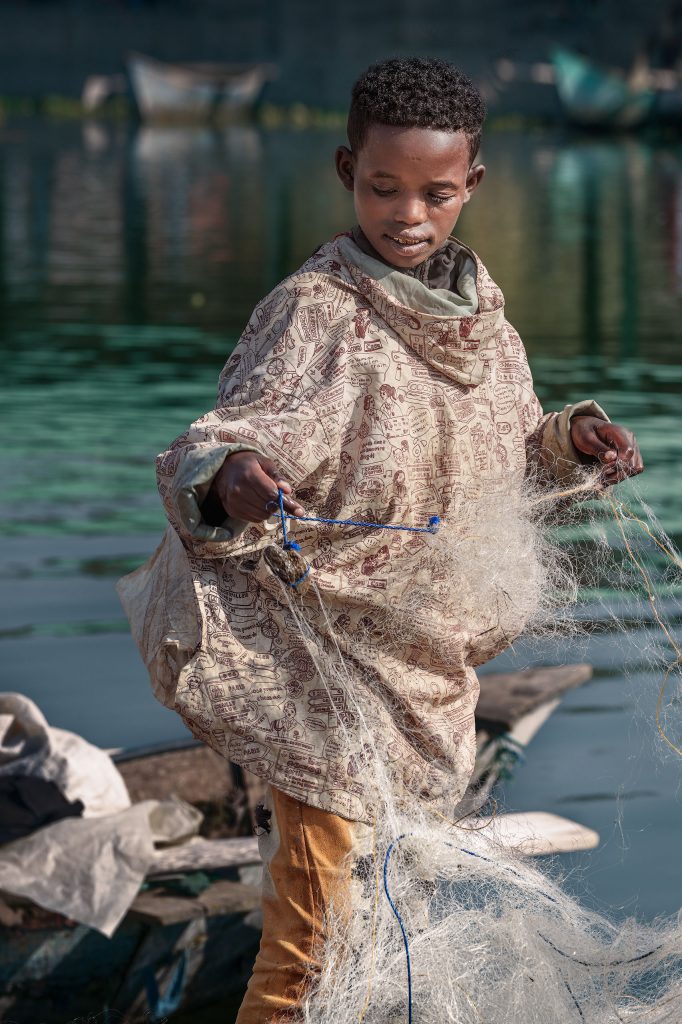 boy and his fish nets