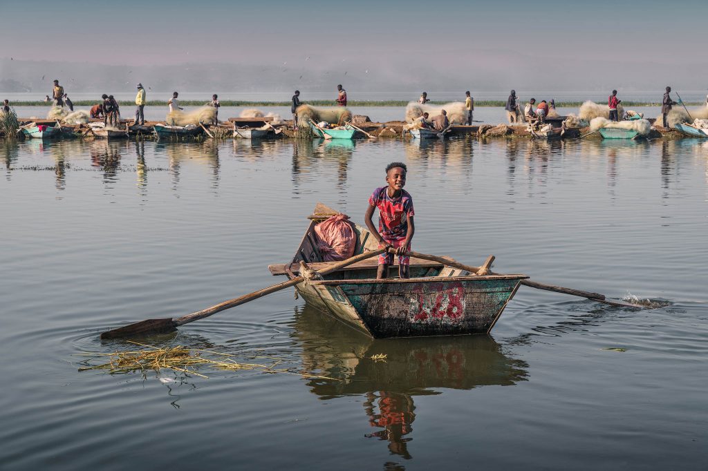 boy rowing a fisherboat
