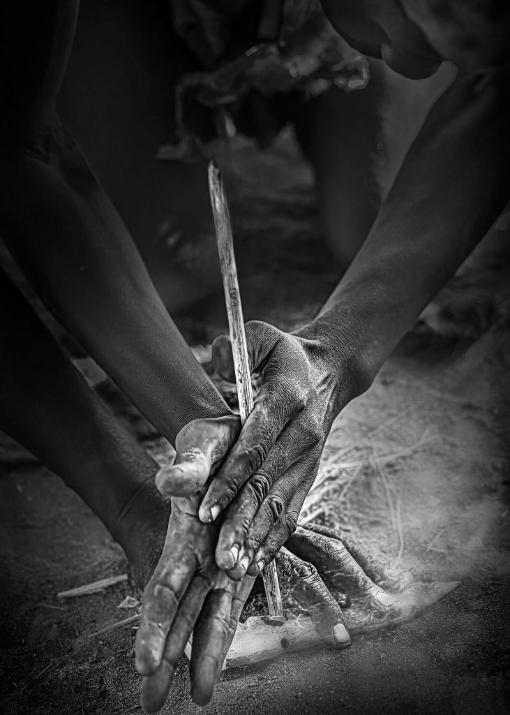 hands drilling to ignite the spark