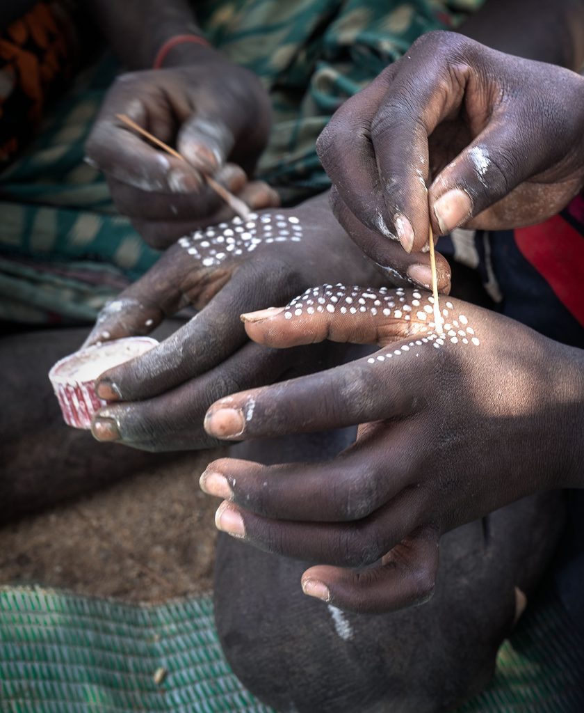 hands of the karo tribe performing their bodyart