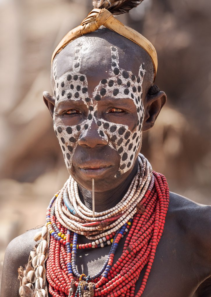 karo woman with leopard painted face