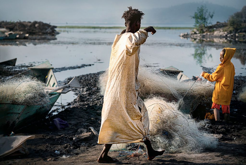 two guys working at the fish market in awassa in the morning