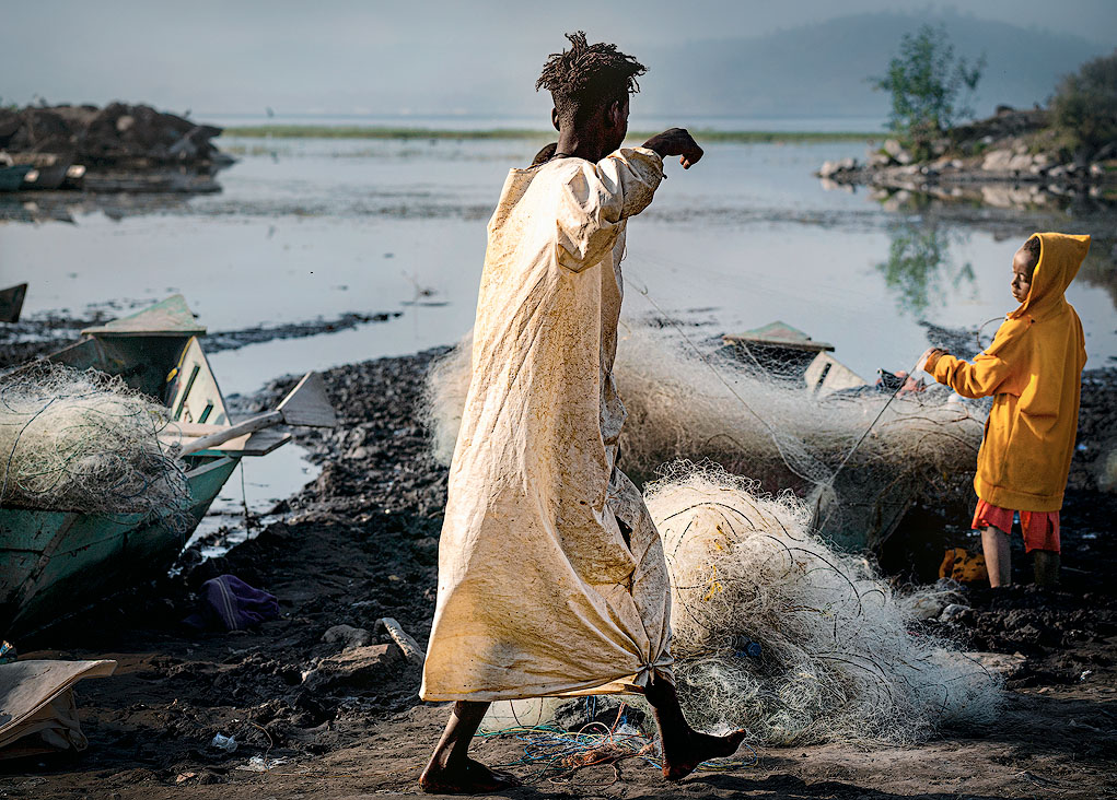 two guys working at the fish market in awassa in the morning