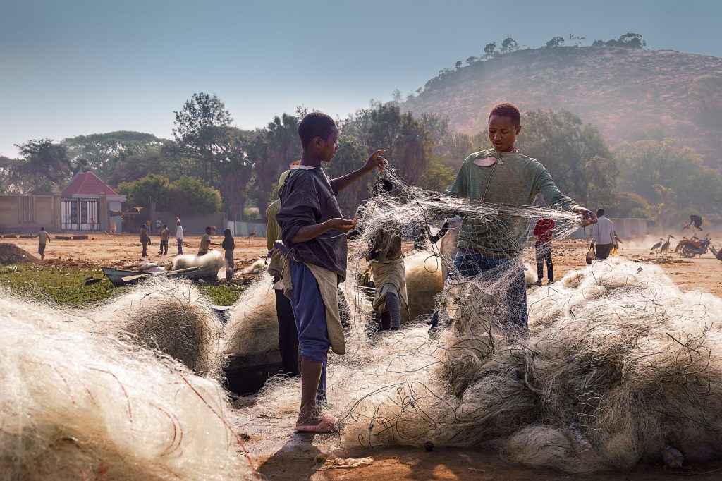 two men sorting nets at the fishmarket in awassa