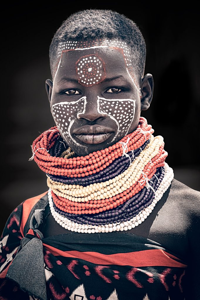 young karo woman with painted face
