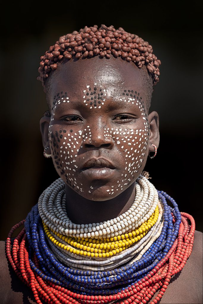 young karo with painted face
